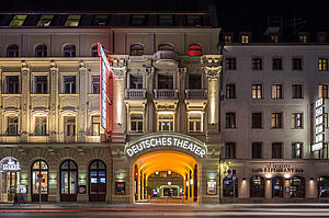 Das Außengebäude des Deutschen Theaters München mit Beleuchtung