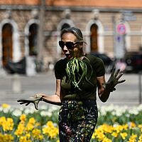 Vocal performer Ruth Geiersberger standing between flowers