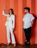 Dvoe Duo standing in front of an orange wall